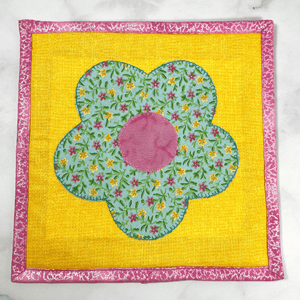 This flower applique potholder is stunning with it's yellow, pink and aqua fabric.  Each Sew Happy Quilting potholder is triple stitched at the edges, washable and highly unique.  Give one of these to your favorite baker or cook and they are sure to smile.