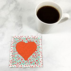 Mug rugs are also known as drink coasters. They are made from 100% cotton fabric, are insulated and washable too. These are great accessories for your home office desk or for your coffee bar area. This particular one is made with a fun coral and aqua speckled fabric background and a solid coral heart appliqued in the center.