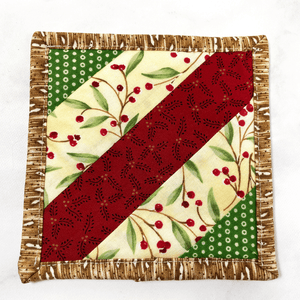 If you love craft kits, check out this quilt kit that will teach you how to make a fabric mug rug aka drink coaster.  Each kit comes with fabric plus printed directions and are mailed to your door.  This one is made with red, green and brown fabric.