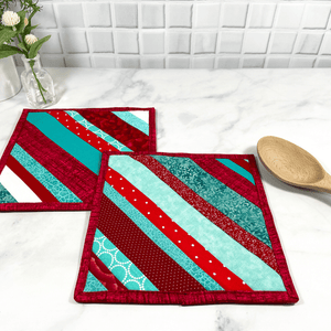 These are a set of two gorgeous red and aqua striped, quilted potholders for your home.  The trivets are made from 100% cotton fabric and are washable.  Practical, yet beautiful when used as hot pads on your kitchen island or dining table.
