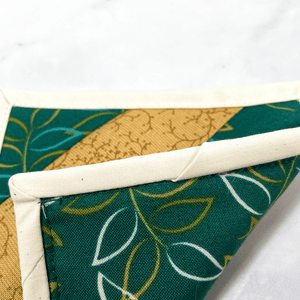 If you love craft kits, check out this quilt kit that will teach you how to make a fabric mug rug aka drink coaster.  Each kit comes with fabric plus printed directions and are mailed to your door.  This one is made with green and gold fabric.