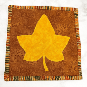 This maple leaf themed quilted potholder is a great accessory for your home.  The trivets are made from 100% cotton fabric and are washable.  Practical, yet beautiful when used as hot pads on your kitchen island or dining table.  Fall and autumn lovers will cherish these.