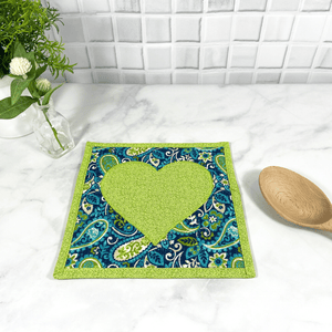 These are gorgeous green and blue heart quilted potholders for your home.  The trivets are made from 100% cotton fabric and are washable.  Practical, yet beautiful when used as hot pads on your kitchen island or dining table.