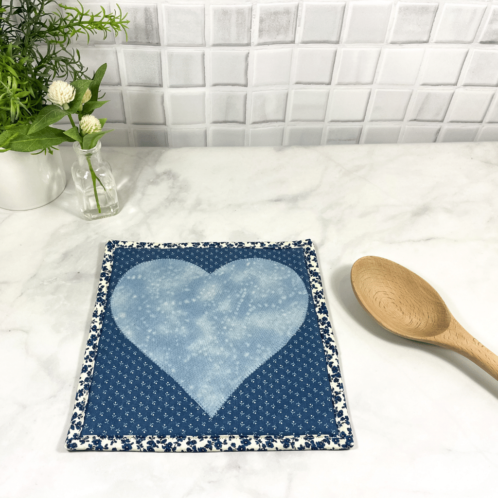 These are gorgeous blue and white quilted potholders with an applique heart in the center.  The trivets are a great addition to your kitchen and are made from 100% cotton fabric and washable too.  Practical yet beautiful when used as hot pads on your kitchen island or dining table.