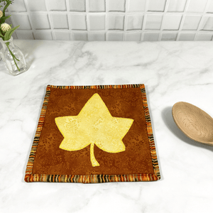 These are yellow and brown maple leaf quilted potholders for your home.  The trivets are made from 100% cotton fabric and are washable.  Practical, yet beautiful when used as hot pads on your kitchen island or dining table.