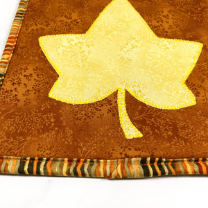 These are yellow and brown maple leaf quilted potholders for your home.  The trivets are made from 100% cotton fabric and are washable.  Practical, yet beautiful when used as hot pads on your kitchen island or dining table.