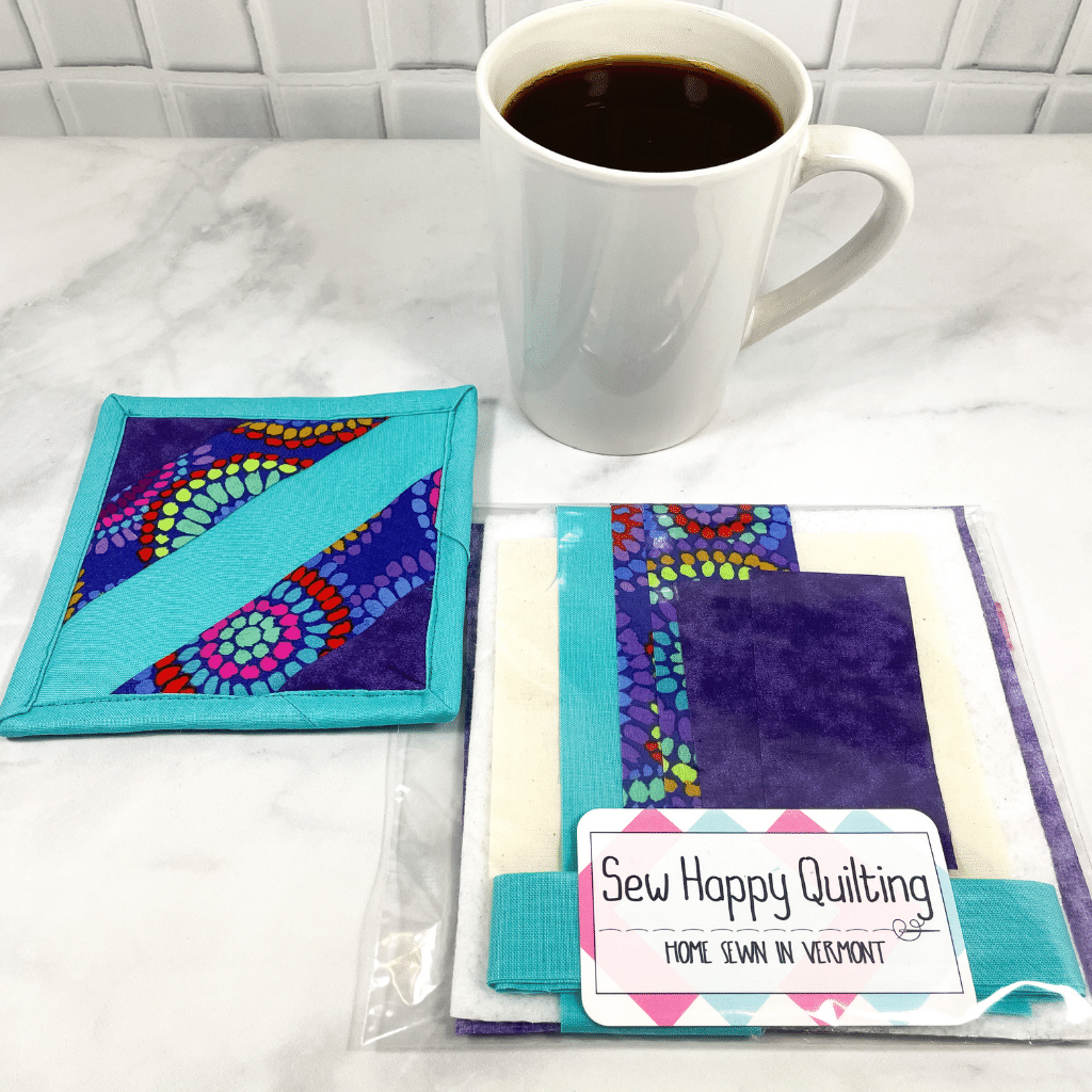 If you love craft kits, check out this quilt kit that will teach you how to make a fabric mug rug aka drink coaster.  Each kit comes with fabric plus printed directions and are mailed to your door.  This one is made with Kaffe Fassett mosaic fabric as the focal point.