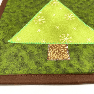 These are gorgeous Christmas tree themed quilted potholders for your home.  The trivets are made from 100% cotton fabric and are washable.  Practical, yet beautiful when used as hot pads on your kitchen island or dining table.