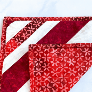 A red and white batik fabric pot holder that was handmade in Vermont.  This potholder is insulated, washable, and will add a splash of color to your kitchen island or dining room table.  The trivets make great gifts for that baker or cook in your life.