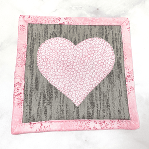 Heart themed mug rugs are also known as drink coasters.  They are made from 100% cotton fabric, are insulated and washable too.  These are great accessories for your home office desk or for your coffee bar area, adding a splash of color and uniqueness.