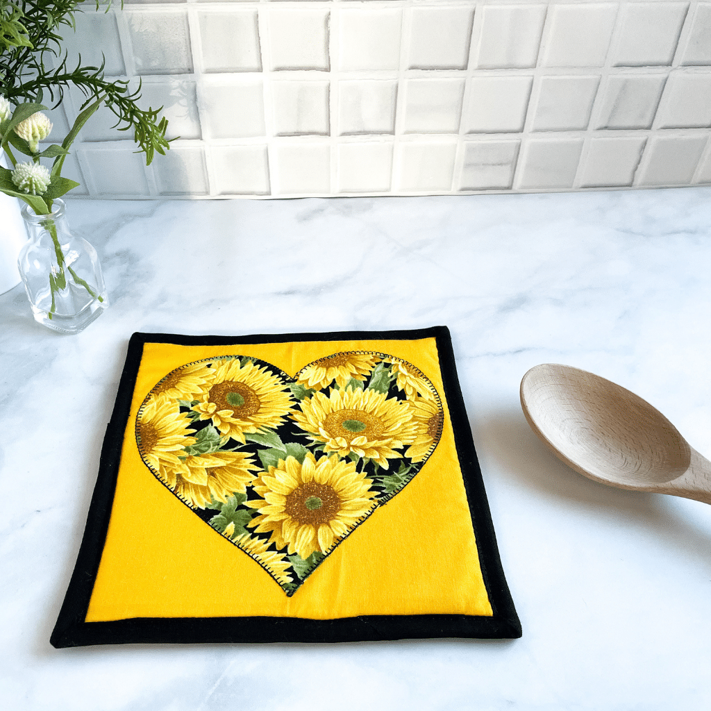 A single heart themed potholder made with a gorgeous sunflower material.  These make great trivets for your hot dishes.  The pot holder is insulated and washable.  They make great gifts for that sunflower lover in your life.