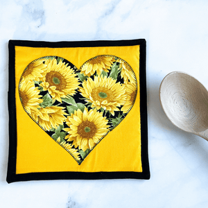 A single heart themed potholder made with a gorgeous sunflower material.  These make great trivets for your hot dishes.  The pot holder is insulated and washable.  They make great gifts for that sunflower lover in your life.