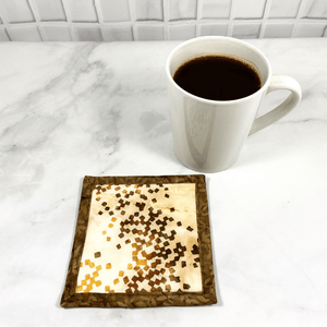Mug rugs are also known as drink coasters.  They are made from 100% cotton fabric, are insulated and washable too.  These are great accessories for your home office desk or for your coffee bar area.  This particular one is made with a stunning brown and beige batik fabric.