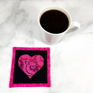 This is a heart themed fabric drink coaster aka mug rug that is made from a gorgeous Kaffe Fassett fabric in the center.  These make great gifts for the one you love.  Washable, insulated and made from 100% cotton.