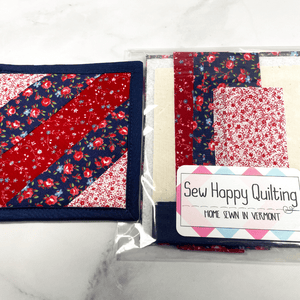 If you love craft kits, check out this quilt kit that will teach you how to make a fabric mug rug aka drink coaster.  Each kit comes with fabric plus printed directions and are mailed to your door.  This one is made with red, white and blue fabric.