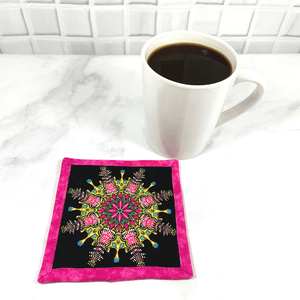 This pink and black mandala patterned mug rug aka drink coaster is so colorful.  It will make a great addition to your coffee table or desk at the office.  These make great gifts paired with the recipient's favorite wine or coffee.