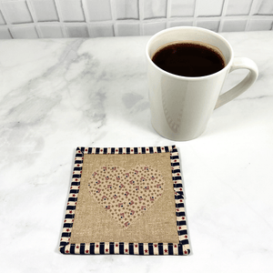 Mug rugs are also known as drink coasters.  They are made from 100% cotton fabric, are insulated and washable too.  These are great accessories for your home office desk or for your coffee bar area.  This particular one has an Americana theme with a heart applique made from small flag fabric.