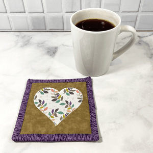 These beautiful cotton fabric drink coasters are great for the coffee lover in your life.  They are also known as mug rugs.  They are washable, unbreakable and add a splash of color to your coffee bar area, desk or table.