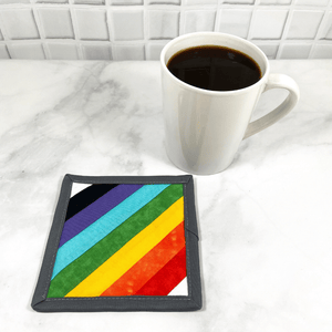 This rainbow mug rug aka drink coaster is such a stunning fabric accessory.  It makes such a great gift for the coffee or wine lover in your live.  It's an accessory that can be used on your table or desk and it looks so darn pretty!