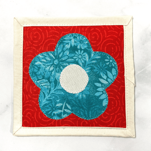 Mug rugs are also known as drink coasters.  They are made from 100% cotton fabric, are insulated and washable too.  These are great accessories for your home office desk or for your coffee bar area.  This particular one is aqua, red and cream with a flower applique in the center.