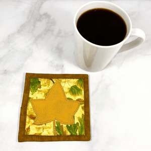 This is a maple leaf themed mug rug aka drink coaster with a gold maple leaf that was appliqued to the front.  These mug rugs make great gifts paired with the recipient's favorite coffee or wine.  The bring a splash of color to any desk or table.