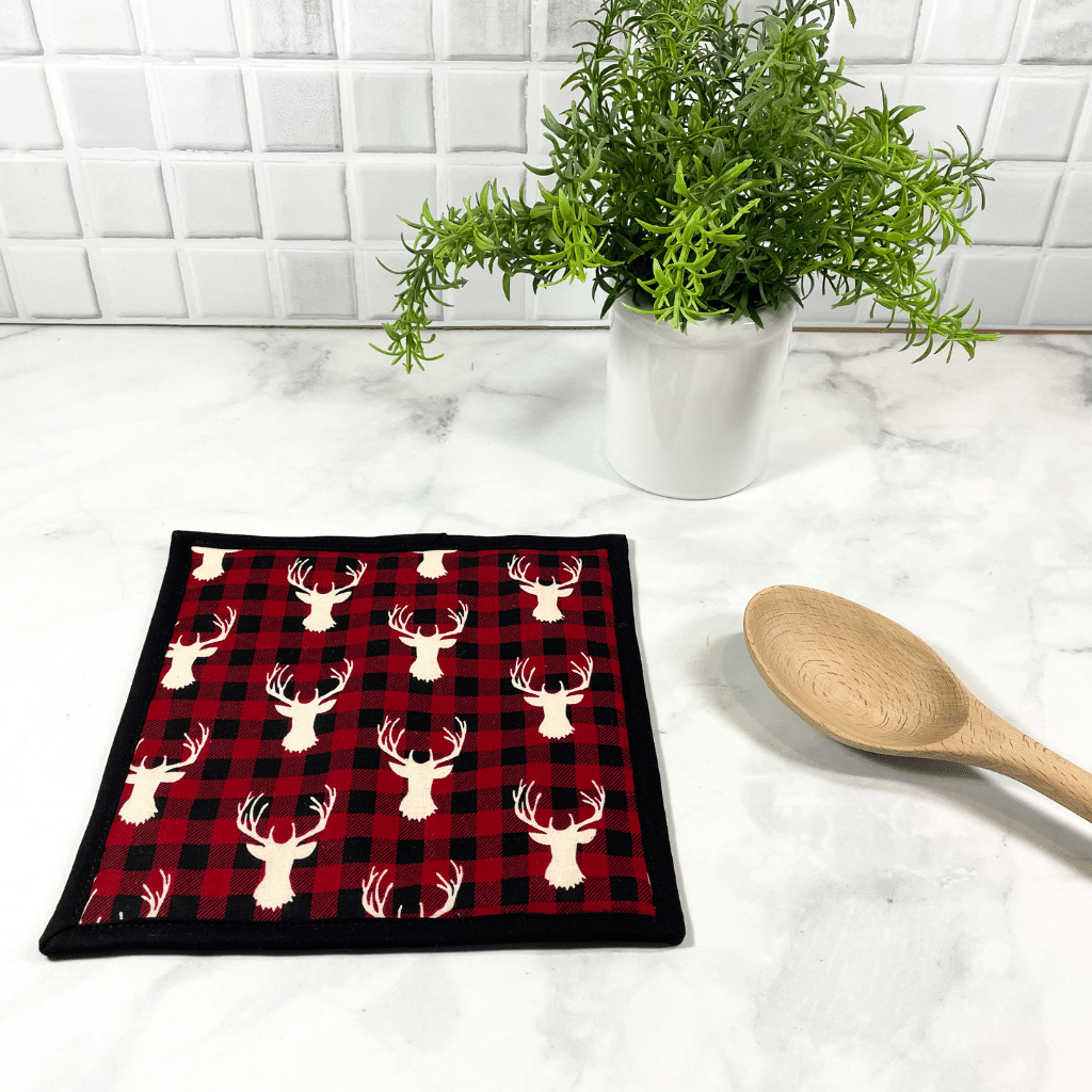 This buffalo plaid deer stag head fabric potholder is very unique and handmade by Sew Happy Quilting.  This trivet for hot dishes will protect your hands as well as your kitchen island counter or dining room table.  Pot holders make great gifts for that baker or cook in your life.
