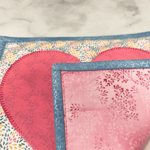 These are gorgeous pink and blue heart themed quilted potholders for your home.  The trivets are made from 100% cotton fabric and are washable.  Practical, yet beautiful when used as hot pads on your kitchen island or dining table.