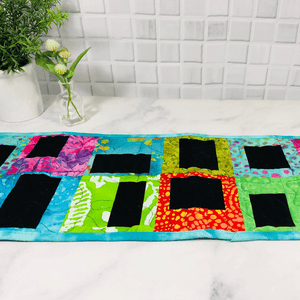 Quilted table runners which are handmade and washable.  They are made from 100% cotton fabric.  These make great centerpieces or a tablescapes for your dining room table.  They are popular wedding gifts and housewarming presents. 