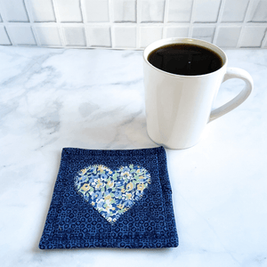 These are blue heart themed mug rugs. Mug rugs are also known as drink coasters.  They are made from 100% cotton fabric, are insulated and washable too.  These are great accessories for your home office desk or for your coffee bar area, adding a splash of color and uniqueness.