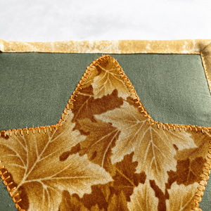 Check out this gorgeous green and gold leaf themed drink coaster.  The mug rug is insulated and washable too.  It makes a great gift for the coffee lover in your life.  And also makes a great desk accessory for your home office decor.