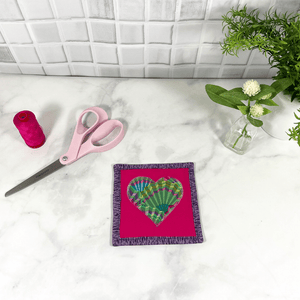 Mug rugs are also known as drink coasters.  They are made from 100% cotton fabric, are insulated and washable too.  These are great accessories for your home office desk or for your coffee bar area, adding a splash of color and uniqueness.  These are made with pink and purple fabric as well as fabric by Kaffe Fassett for the heart and the backing fabric.