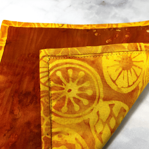 These are gorgeous quilted potholders for your home.  The trivets are made from 100% cotton fabric and are washable.  Practical, yet beautiful when used as hot pads on your kitchen island or dining table.  Yellow and Orange batik fabric was used for this pot holder.